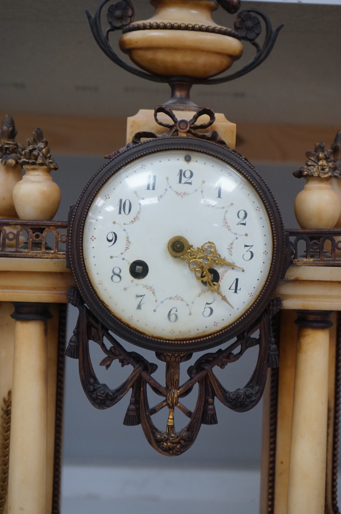 A French gilt metal and alabaster mantel clock, striking on a bell, with pendulum, 49cm high